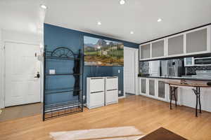 Kitchen featuring decorative backsplash, light hardwood / wood-style flooring, and stainless steel appliances