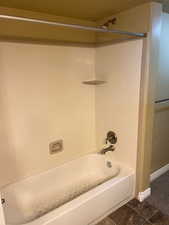 Bathroom featuring shower / bathing tub combination and tile patterned floors