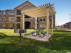 View of home's community featuring a yard and a pergola