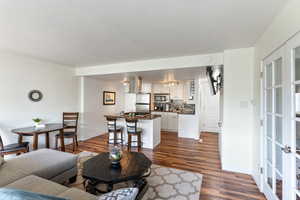 Living room with french doors and dark hardwood / wood-style floors