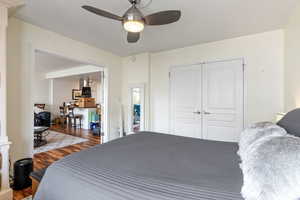 Bedroom with ceiling fan, a closet, and hardwood / wood-style flooring