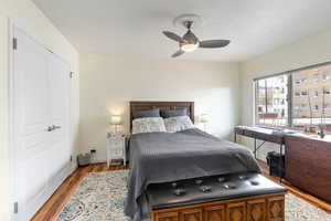 Bedroom with a closet, hardwood / wood-style floors, and ceiling fan