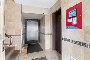 Interior space featuring tile patterned floors and tile walls