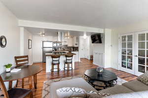 Living room with french doors and wood-type flooring