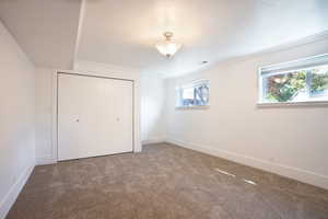 Unfurnished bedroom featuring carpet flooring, a closet, and ornamental molding