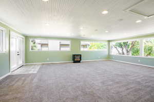 Unfurnished living room with light colored carpet