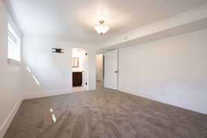 Empty room with carpet flooring and crown molding