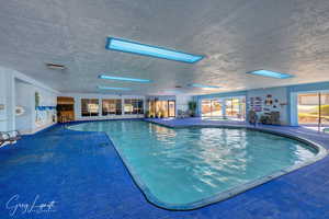 View of pool with a skylight