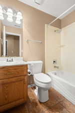 Full bathroom featuring tile patterned flooring, shower / bathing tub combination, vanity, and toilet