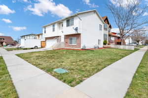 View of front facade with a garage and a front yard