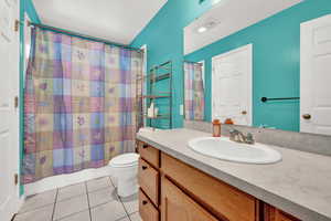 Bathroom featuring tile patterned floors, vanity, and toilet