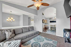 Carpeted living room featuring ceiling fan