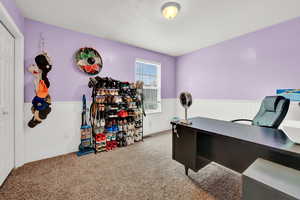 Carpeted office space featuring a textured ceiling