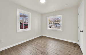 Spare room with light hardwood / wood-style flooring and a healthy amount of sunlight