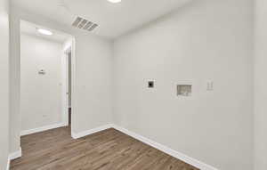 Laundry area featuring hardwood / wood-style floors, hookup for a washing machine, and electric dryer hookup