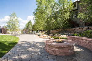 View of home's community featuring a patio and a fire pit