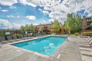 View of swimming pool featuring a pergola and a patio area