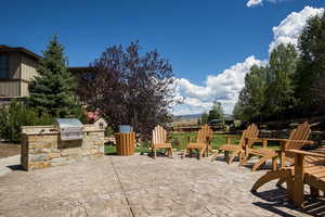 View of patio / terrace featuring a grill and an outdoor kitchen