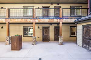 Rear view of house with a balcony and a patio