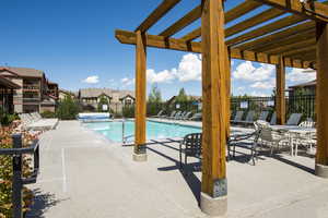 View of swimming pool featuring a pergola and a patio area