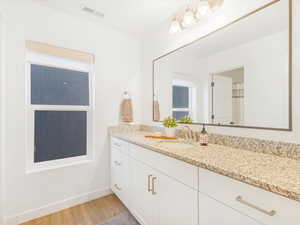 Bathroom with hardwood / wood-style floors and vanity