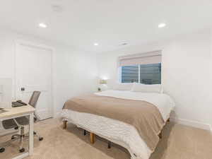 Bedroom featuring light colored carpet