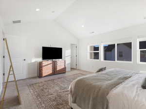 Bedroom featuring carpet and high vaulted ceiling