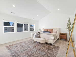 Carpeted bedroom featuring lofted ceiling