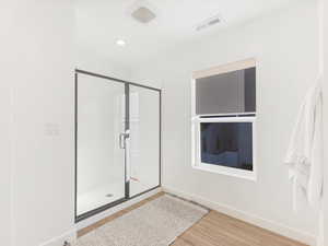 Bathroom featuring walk in shower and hardwood / wood-style flooring