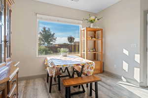 Dining space featuring a healthy amount of sunlight and light hardwood / wood-style floors