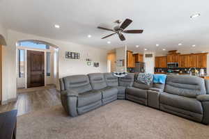 Living room featuring ceiling fan and light hardwood / wood-style flooring