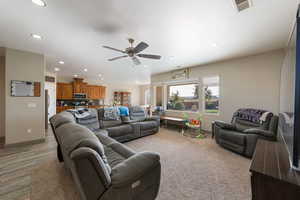 Living room with ceiling fan and light wood-type flooring