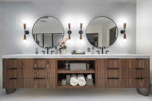 Bathroom with vanity and tile walls