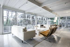 Sunroom featuring beamed ceiling