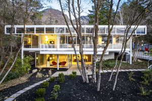 Rear view of property featuring a mountain view, a patio, and a balcony