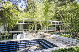 View of swimming pool with a sunroom