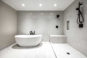 Bathroom with independent shower and bath and tile walls