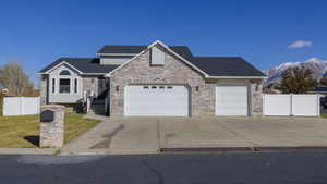 View of front of house with a mountain view and a garage