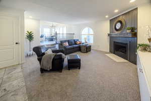 Living room with a chandelier and light colored carpet