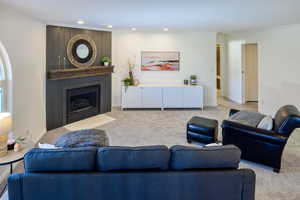 Carpeted living room with crown molding