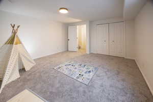 Unfurnished bedroom with a closet and light colored carpet