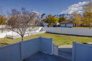 View of yard with a mountain view and a garage