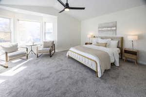 Bedroom with ceiling fan, carpet, and lofted ceiling