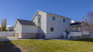 Back of house with a yard, a patio, and central AC unit