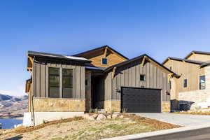 View of front facade with cooling unit and a garage