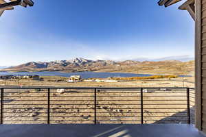 Balcony featuring a water and mountain view