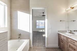 Bathroom featuring tile patterned flooring, vanity, and ceiling fan