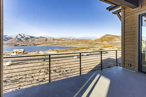 Balcony with a water and mountain view