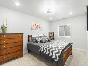 Carpeted bedroom with a textured ceiling