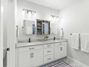 Bathroom with tile patterned floors and vanity